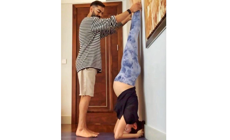 This pic of Virat Kohli helping pregnant wife Anushka Sharma do yoga will win your hearts