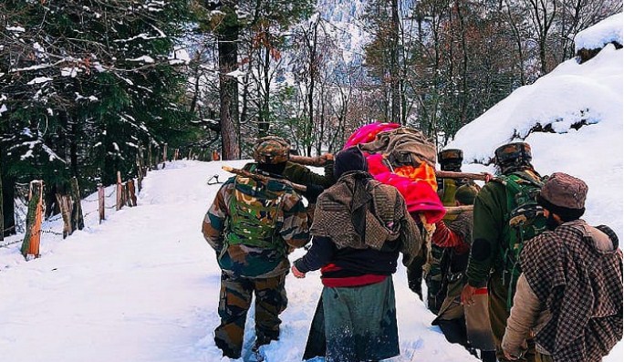 J&K: Army jawans wade through knee-deep snow to carry pregnant woman to hospital